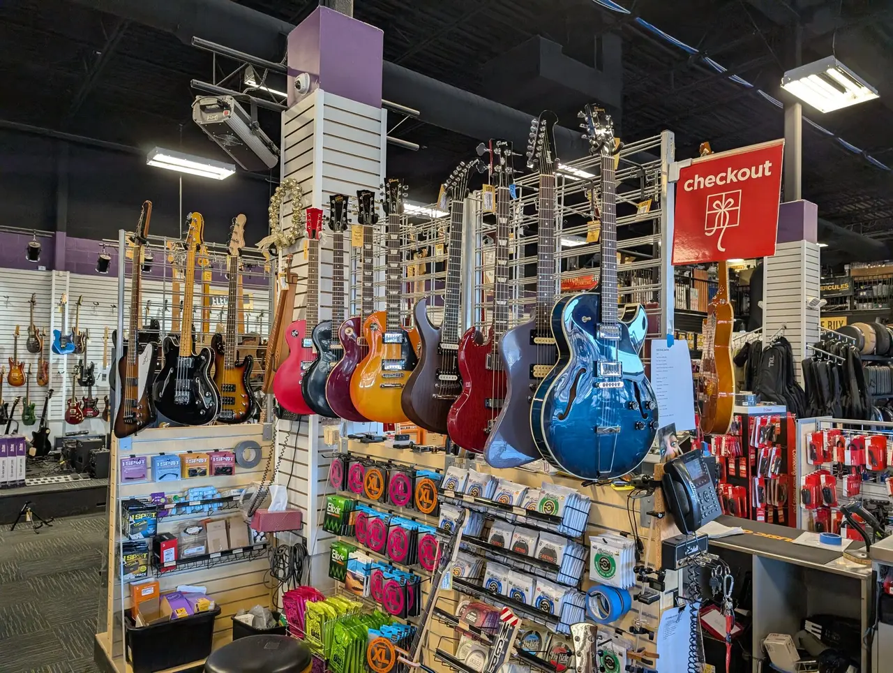 Used guitars on the wall at Music Go Round Louisville